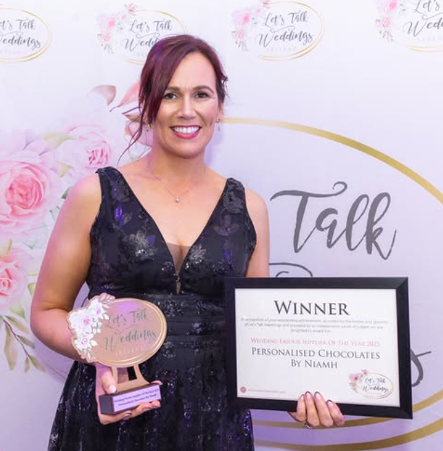 Niamh holding her Let's Talk Weddings Wedding Favour Supplier of the Year 2025 trophy and winner certificate